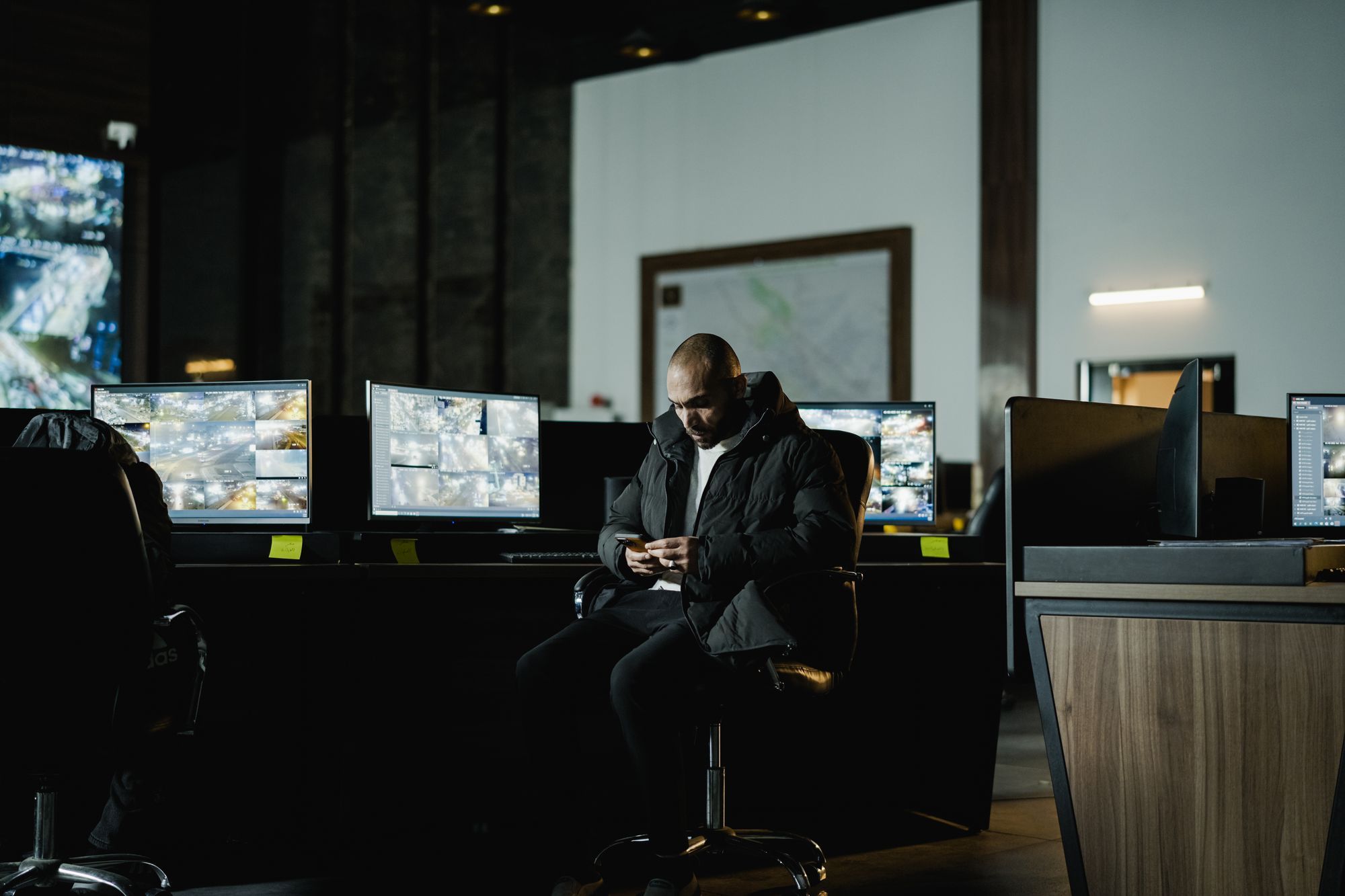 An operator monitoring CCTV screens in a security control room